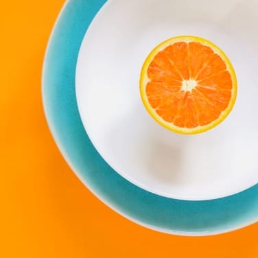 a picture of an orange on a plate